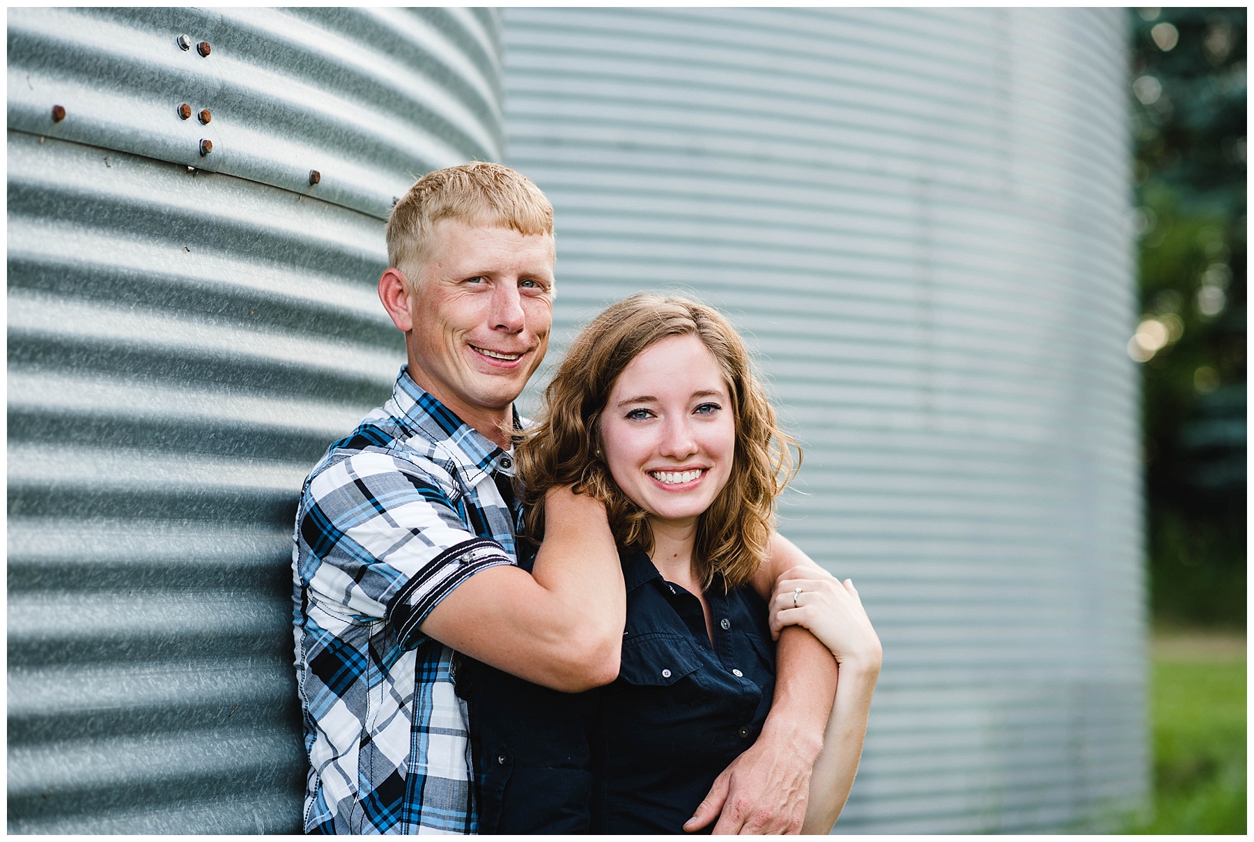 country couple in front of silo
